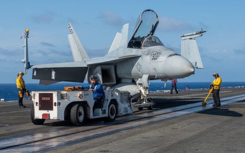 US Navy FA-18 Super Hornet being towed onboard USS Truman aircraft carrier (2)
