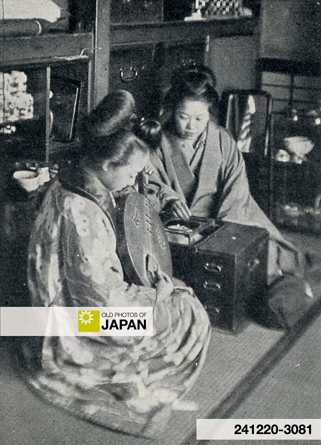 A Japanese woman plays the gekkin while seated next to a hibachi, 1911 A Japanese woman plays the gekkin while seated next to a hibachi, 1911