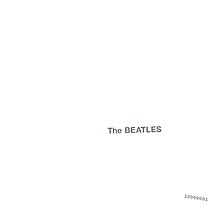 The words "The Beatles" embossed on a plain white background, with a serial number in the lower right