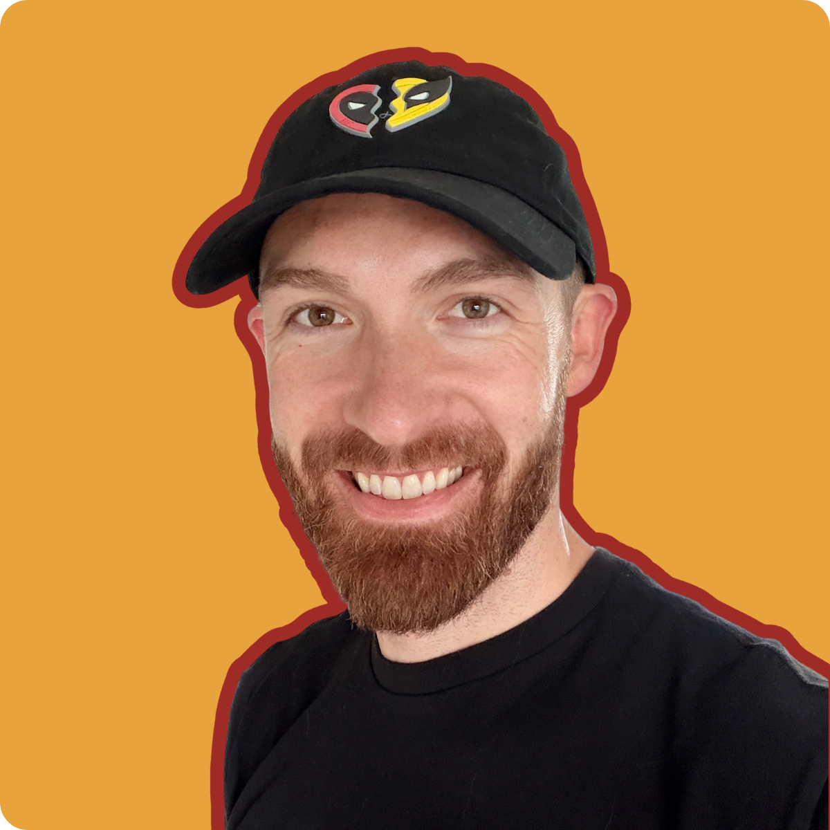 Gannon smiling in a black Deadpool & Wolverine cap and black T-shirt against an amber background. Gannon smiling in a black Deadpool & Wolverine cap and black T-shirt against an amber background.