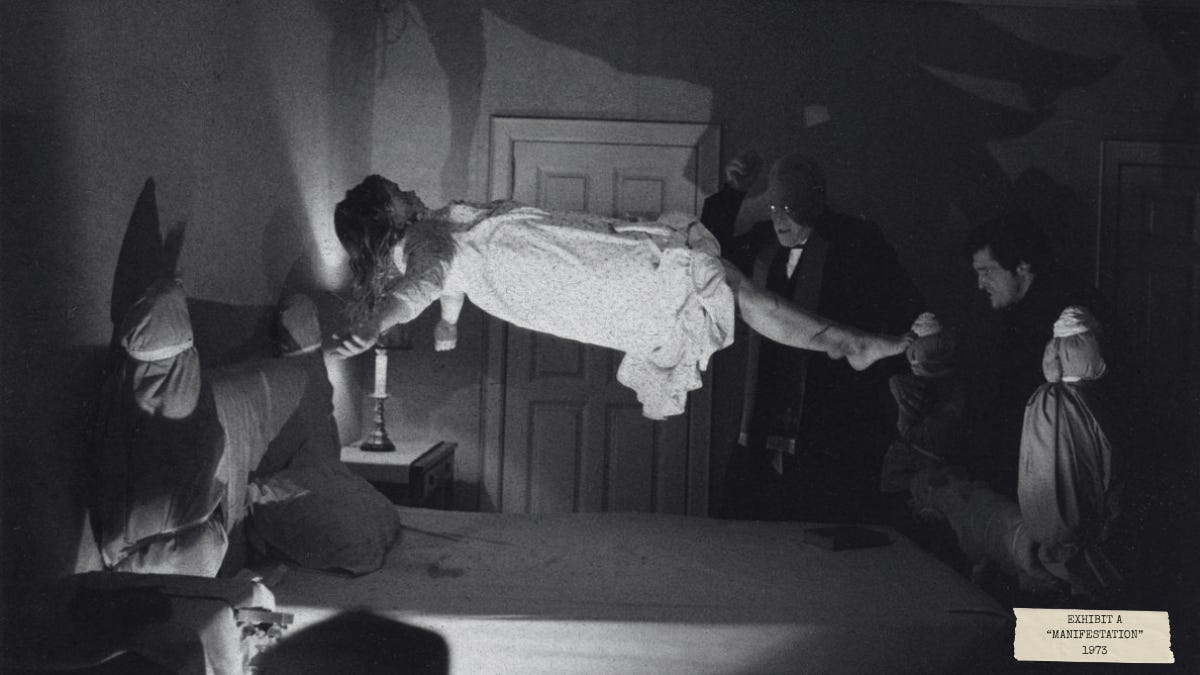 Black-and-white still from The Exorcist (1973) showing Regan MacNeil levitating above her bed during an exorcism ritual, surrounded by priests in a dimly lit bedroom.