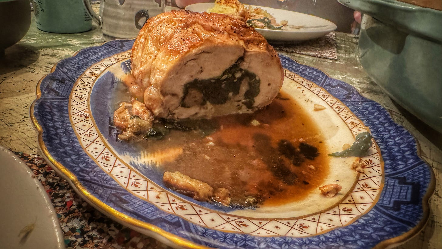 A ballotine stuffed with bead, cheese, and spinach, cut crosswise to reveal the filling, sitting on a carving platter A ballotine stuffed with bead, cheese, and spinach, cut crosswise to reveal the filling, sitting on a carving platter