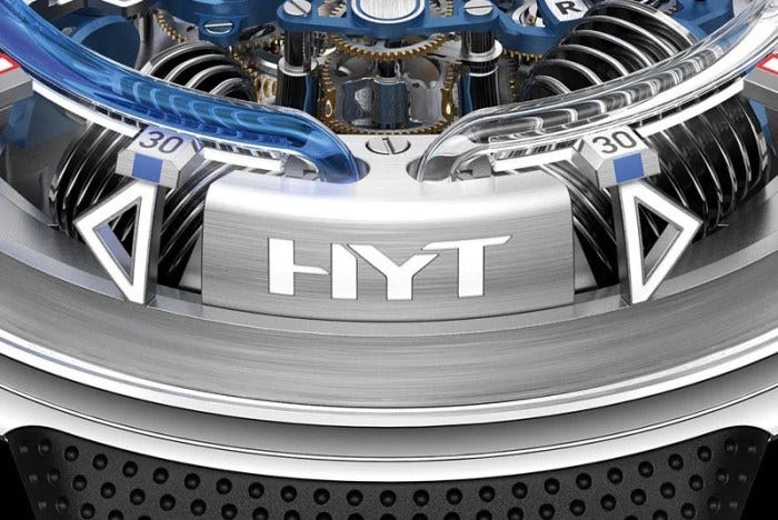 At 6 o’clock, the colored fluid flows backward around the dial to its original position. At 6 o’clock, the colored fluid flows backward around the dial to its original position.