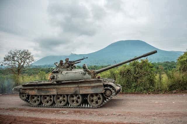 A manned battle tank heaves under dark rainclouds A manned battle tank heaves under dark rainclouds