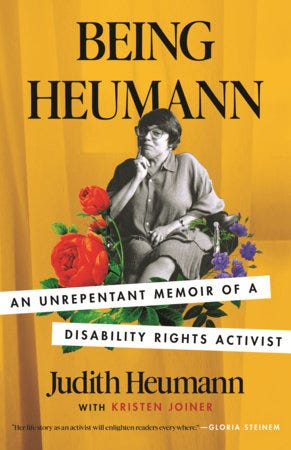 Book cover of Being Heumann: An Unrepentant Memoir of a Disability Rights Activist by Judith Heumann and Kristen Joiner. The background is a yellow-orange color and in the center is a black and white image of Judith, a white Jewish disabled woman in a wheelchair. She has dark hair and is wearing glasses. One of her hands is resting under her chin. Around Judith are illustrations of colorful flowers. Book cover of Being Heumann: An Unrepentant Memoir of a Disability Rights Activist by Judith Heumann and Kristen Joiner. The background is a yellow-orange color and in the center is a black and white image of Judith, a white Jewish disabled woman in a wheelchair. She has dark hair and is wearing glasses. One of her hands is resting under her chin. Around Judith are illustrations of colorful flowers.