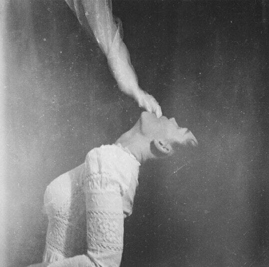 This may contain: an old black and white photo of a woman bending over
