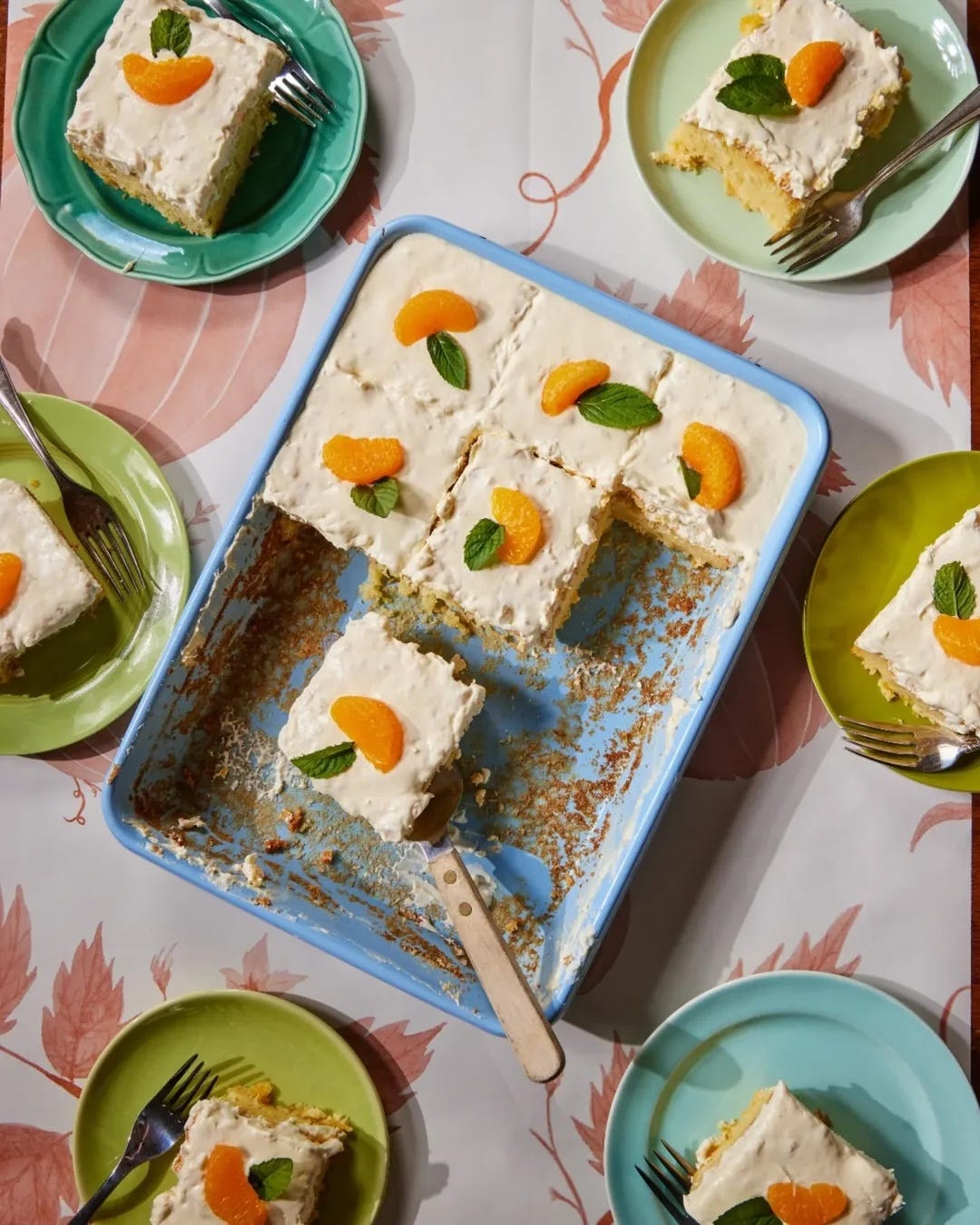 sliced up cake in a baking dish with colorful plates with slices of cake displayed on a floral table cloth sliced up cake in a baking dish with colorful plates with slices of cake displayed on a floral table cloth