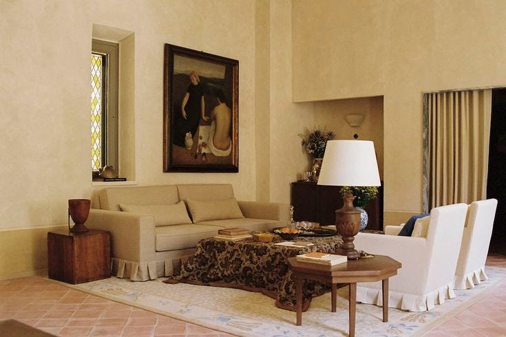 This may contain: a living room filled with furniture and a painting on the wall