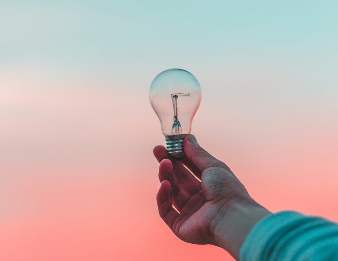 person holding light bulb