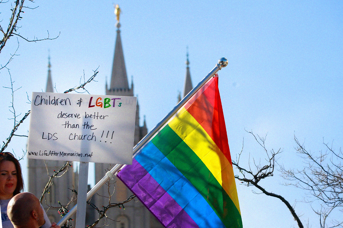 Protestors hold pride flags and signs in front of the Historic Mormon Temple on November 14, 2015 in Salt Lake City, Utah.