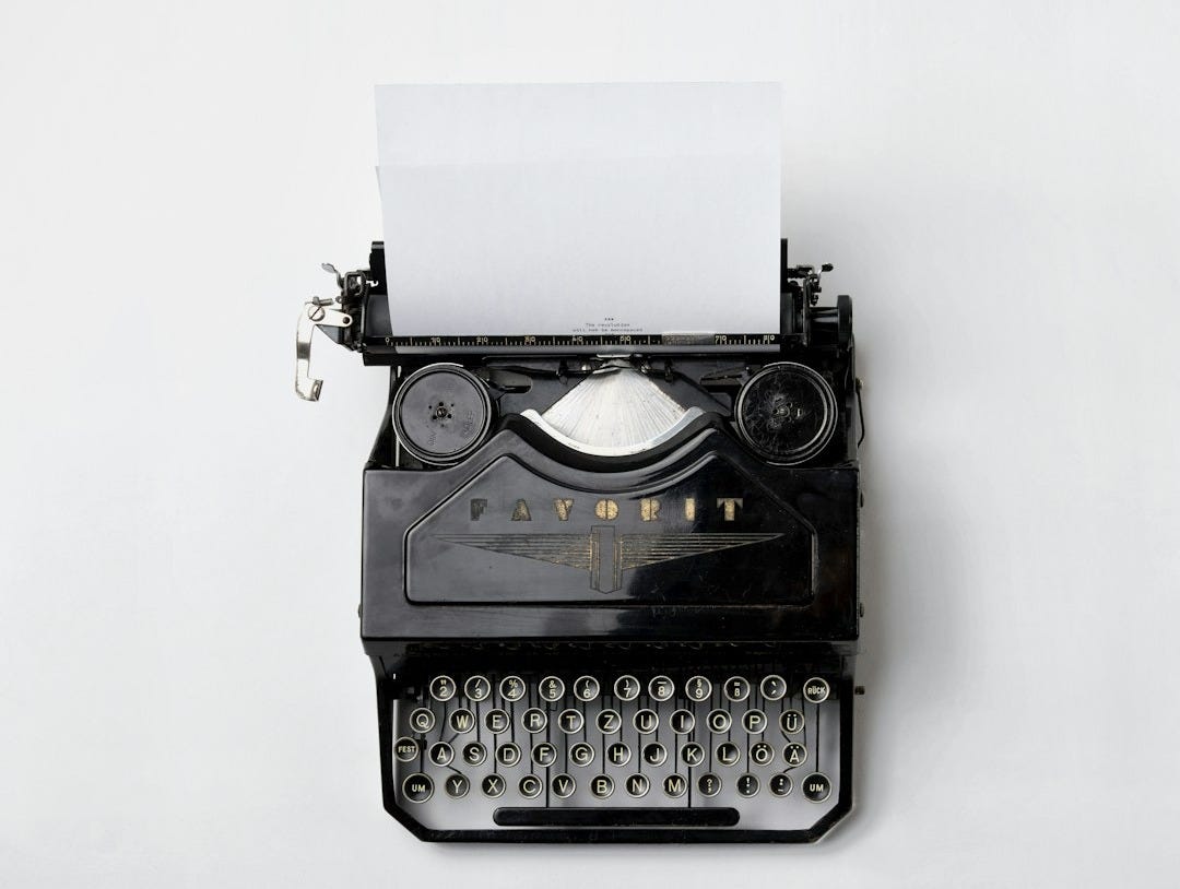 black Fayorit typewriter with printer paper
