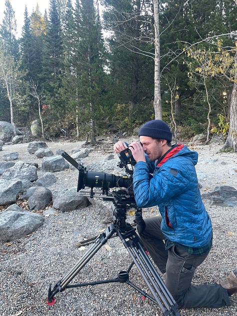 Images from Jackson Wild Summit in Grand Teton National Park in Wyoming. Graham looking through the viewfinder of a camera on a tripod. 3 people taking photos of the mountains at sunrise. 4 people sitting on stage at a Summit workshop.
