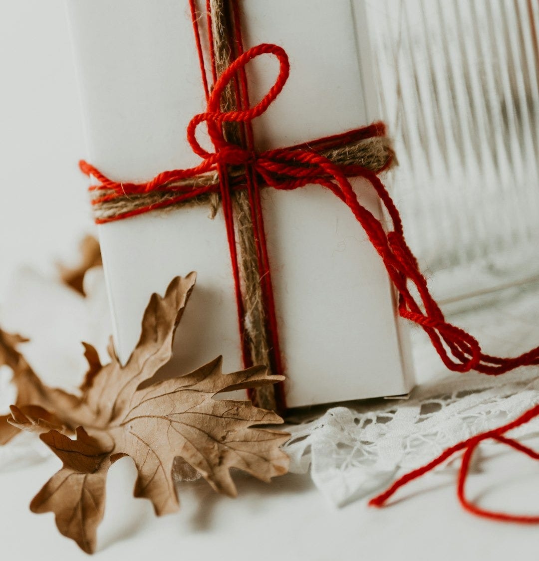 a red bow on a white surface