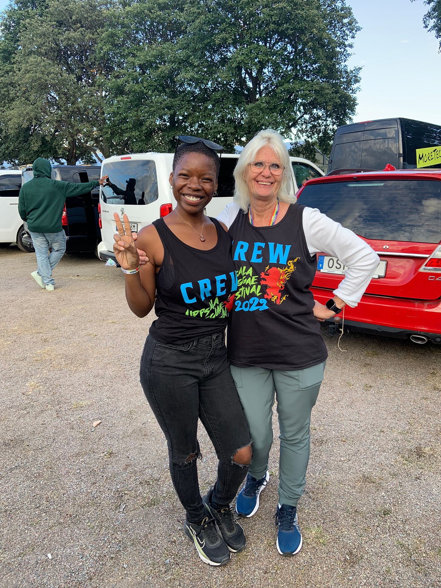 two women smiling, working backstage at a festival