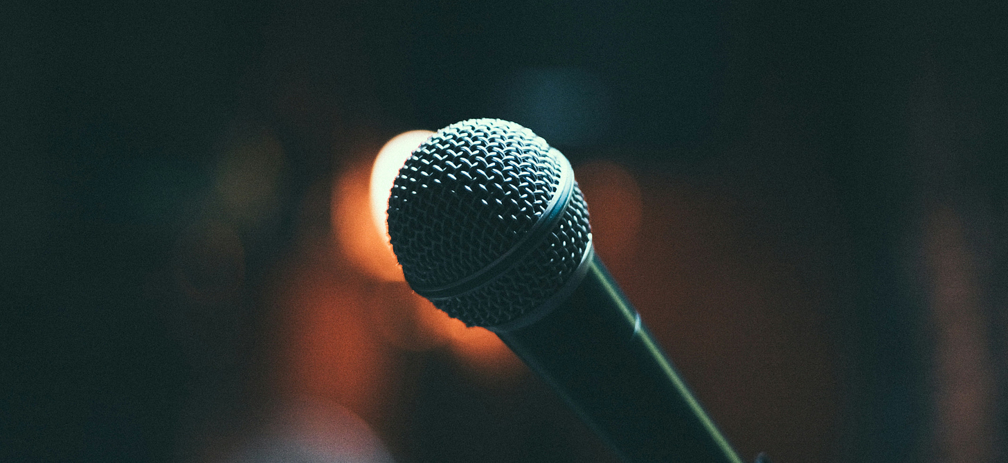 A single microphone in front of a blurry background A single microphone in front of a blurry background