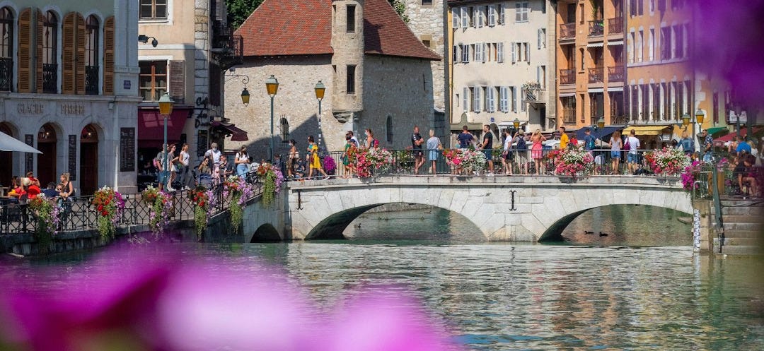 people walking on river near brown concrete building during daytime