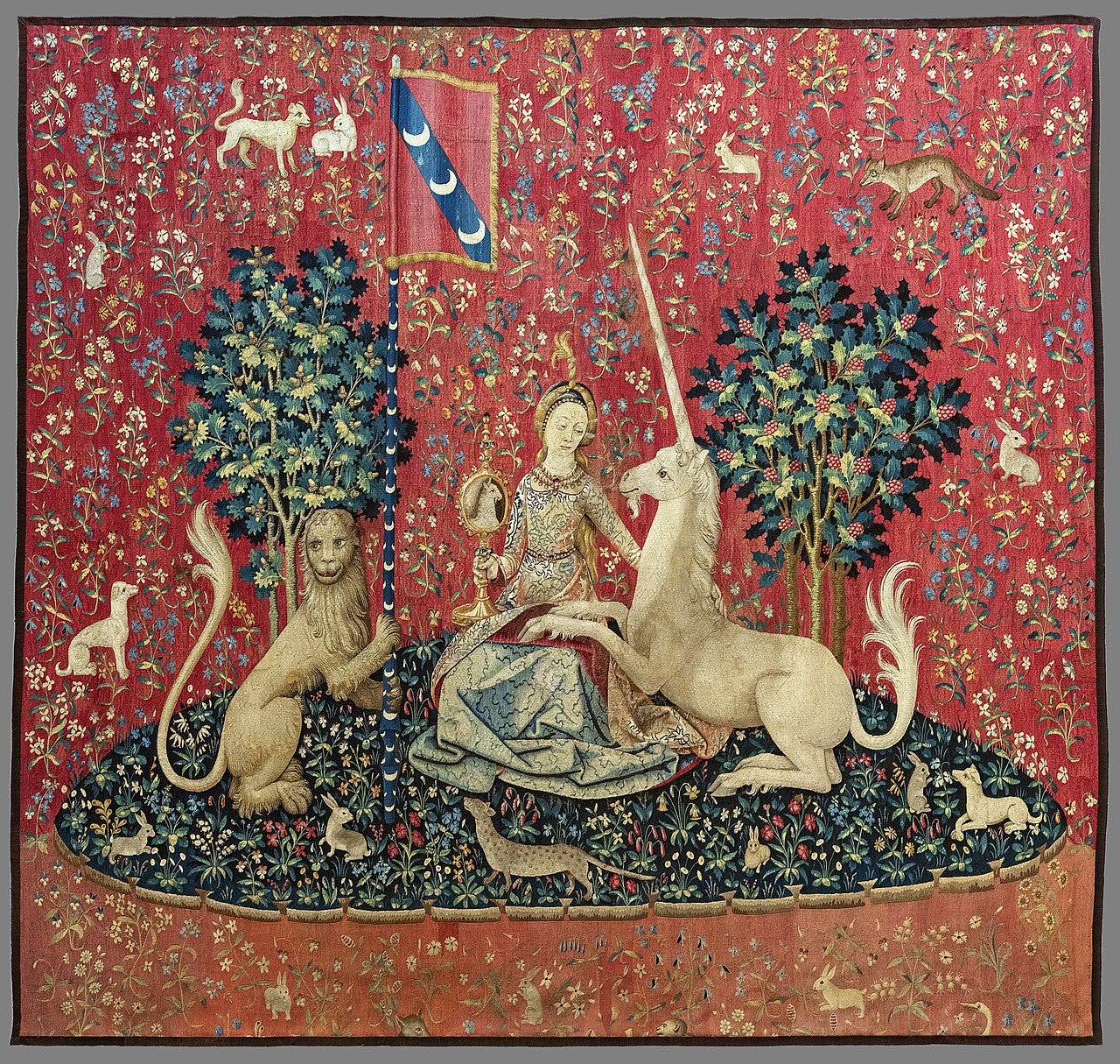 Sight, from The Lady and the Unicorn at the Musée de Cluny: a seated lady tilts a hand mirror so that a unicorn resting its hooves in her lap can see its own face Sight, from The Lady and the Unicorn at the Musée de Cluny: a seated lady tilts a hand mirror so that a unicorn resting its hooves in her lap can see its own face