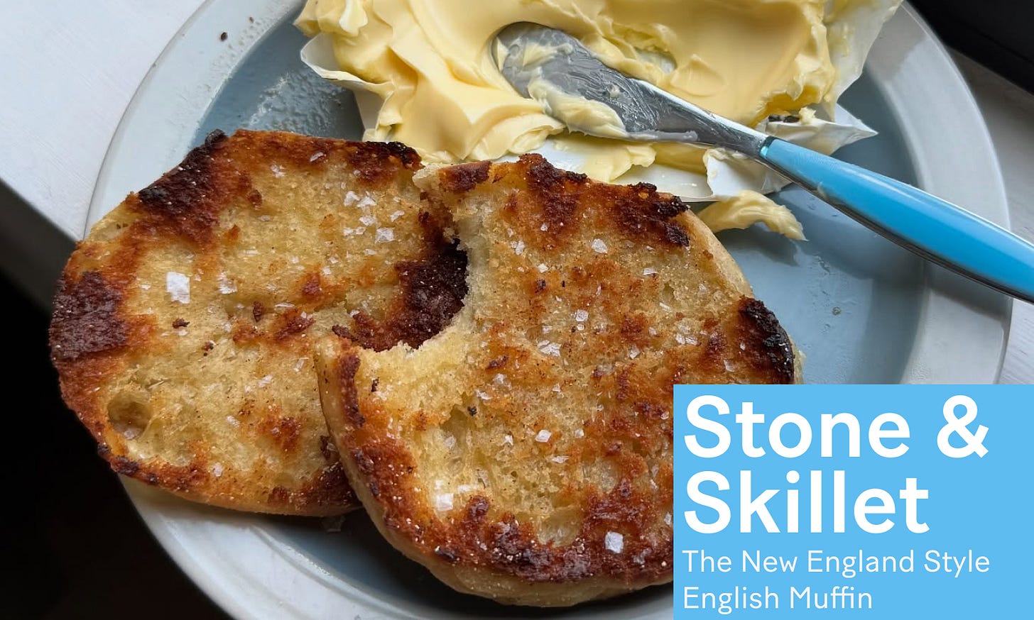 English muffins on a plate with butter.