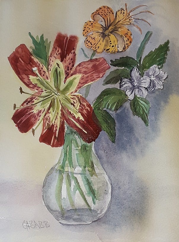 yard lilies in a small glass vase