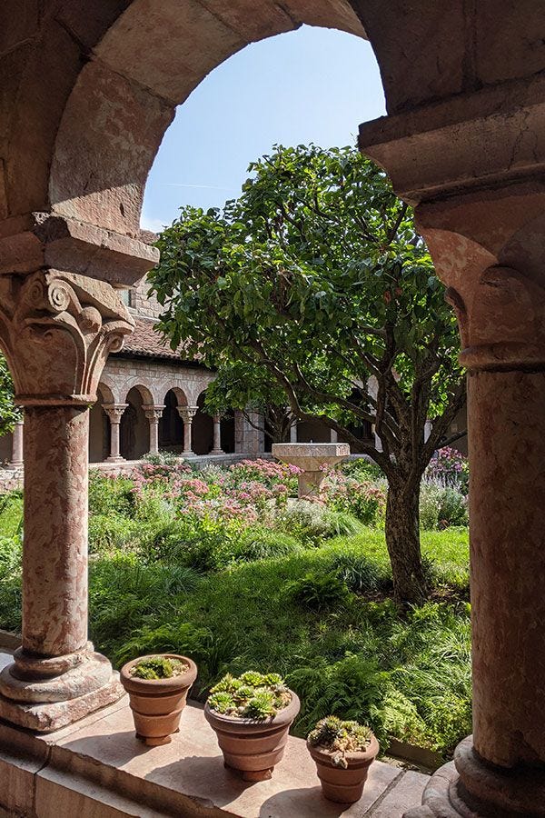 This may contain: three pots with plants in them sitting on the outside wall of an old stone building