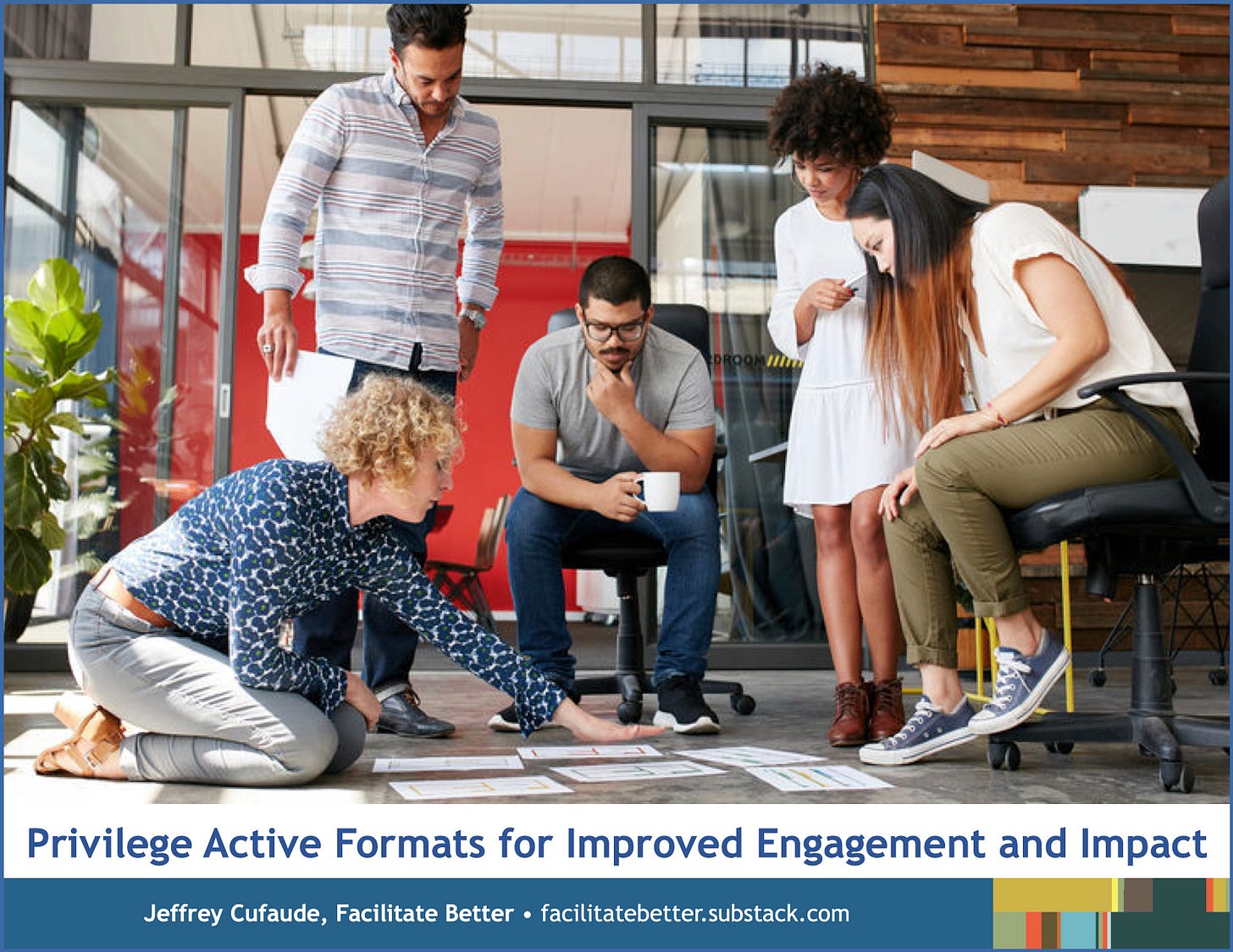 A diverse small group of young professionals are working together and discussing some project while looking at multiple sheets of paper with information on the floor.  One woman is moving the papers while the other four look on.