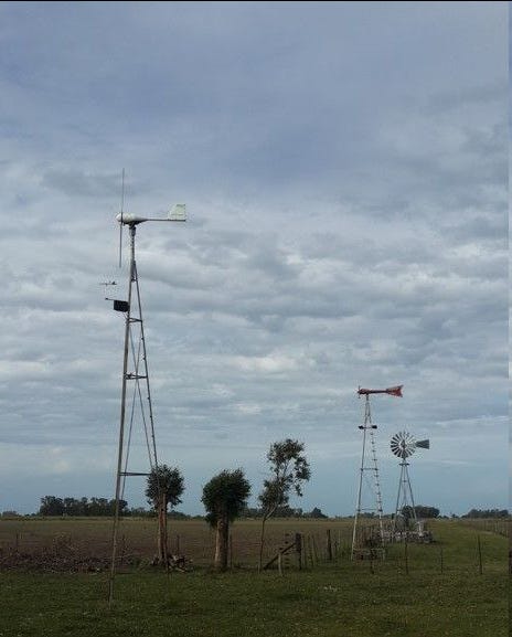 A trio of small-scale farm windmills, including a Wincharger in the middle.