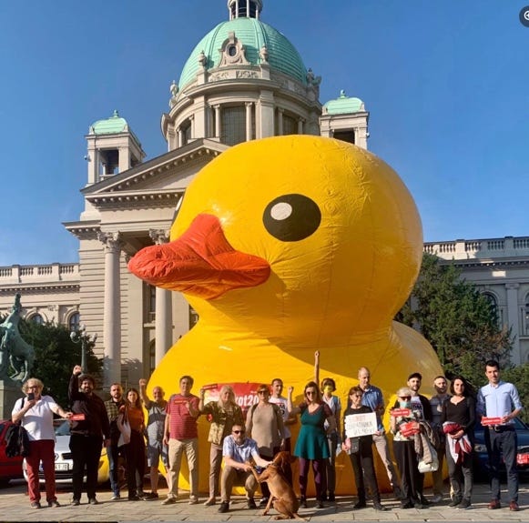 A group of people posing in front of a large inflatable duck

AI-generated content may be incorrect.