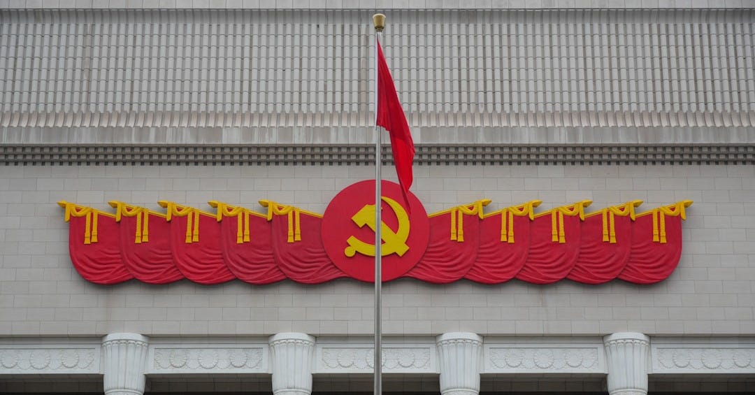 Chinese communist party emblem and flag on a building.