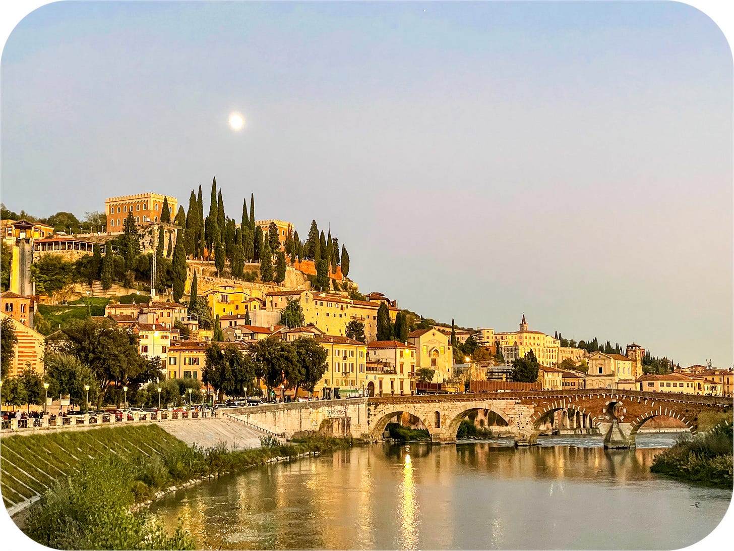The moon rises over Verona, Italy