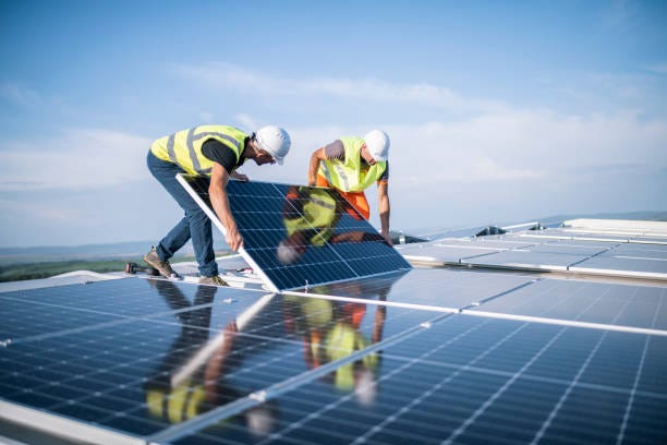 Two workers installing photovoltaic system.