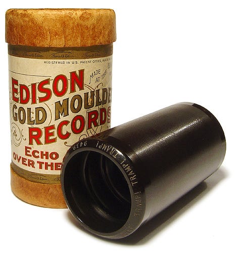 Edison Gold Moulded Records wax cylinder and original cylindrical storage container.