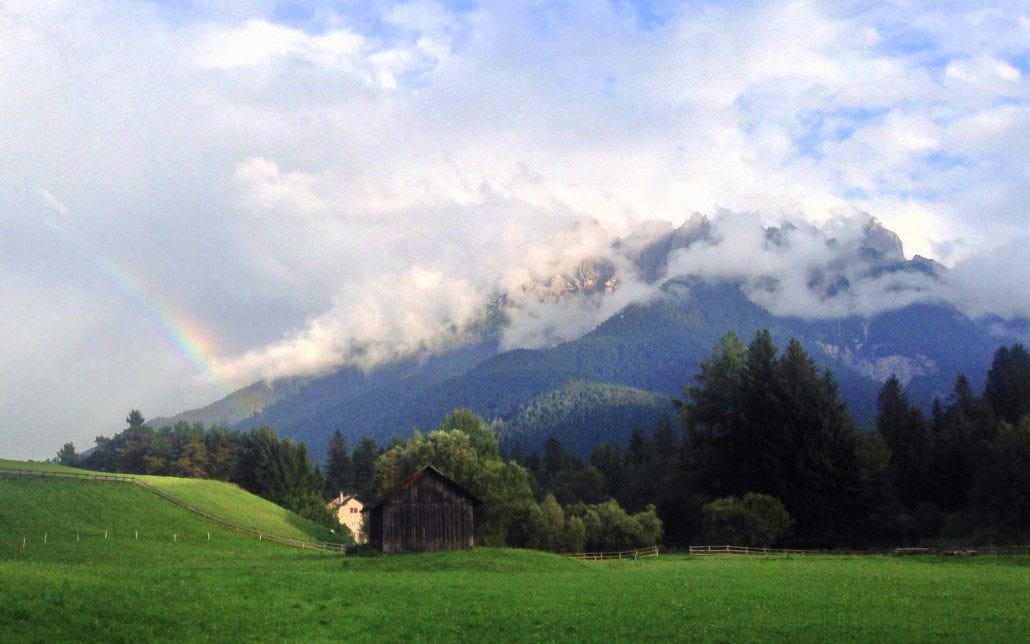 An evening rainbow on the mountains behind Toblach, Italy. An evening rainbow on the mountains behind Toblach, Italy.