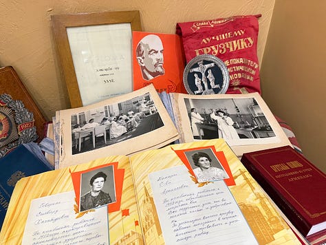 Photos from the Concours Mondial de Bruxelles cultural program in Armenia, including a group dinner at a long candlelit table, a meeting room with the Armenian minister of economy beneath the national flag, a display of Soviet-era wine industry memorabilia and archival photos, aging wine barrels in a cellar, a group photo overlooking Yerevan with Mount Ararat in the distance, illuminated performers at the Garni Temple at night, traditional dancers performing acrobatics, a crowd joining a folk dance circle outdoors, and a large karas amphora covered in visitor signatures." Let me know if you'd like it trimmed or reordered to lead with a particular image.