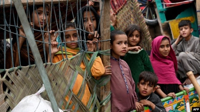Afghan refugees arrive on trucks from Pakistan at the Afghanistan-Pakistan Torkham border in Nangarhar province on Nov. 1, 2023.
