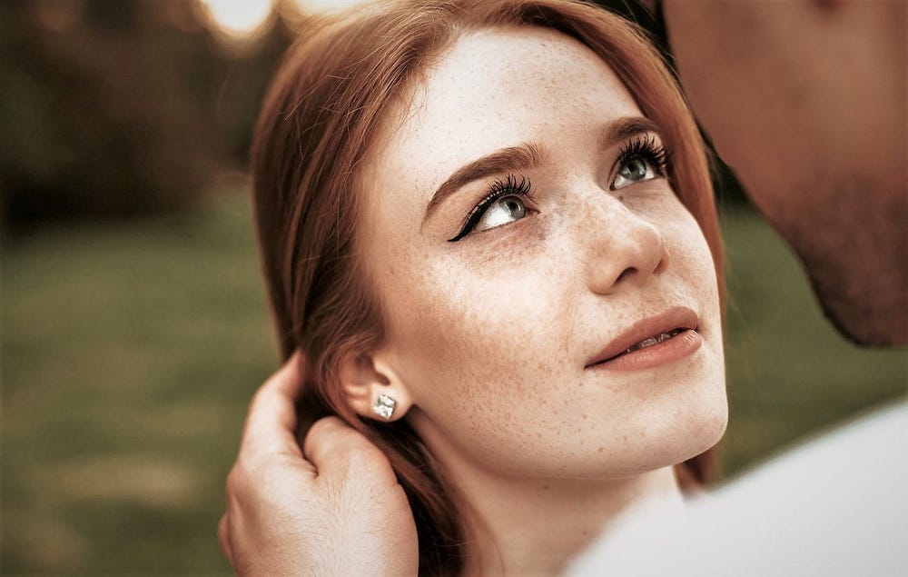 A beautiful ginger haired young woman about to be kissed. A beautiful ginger haired young woman about to be kissed.