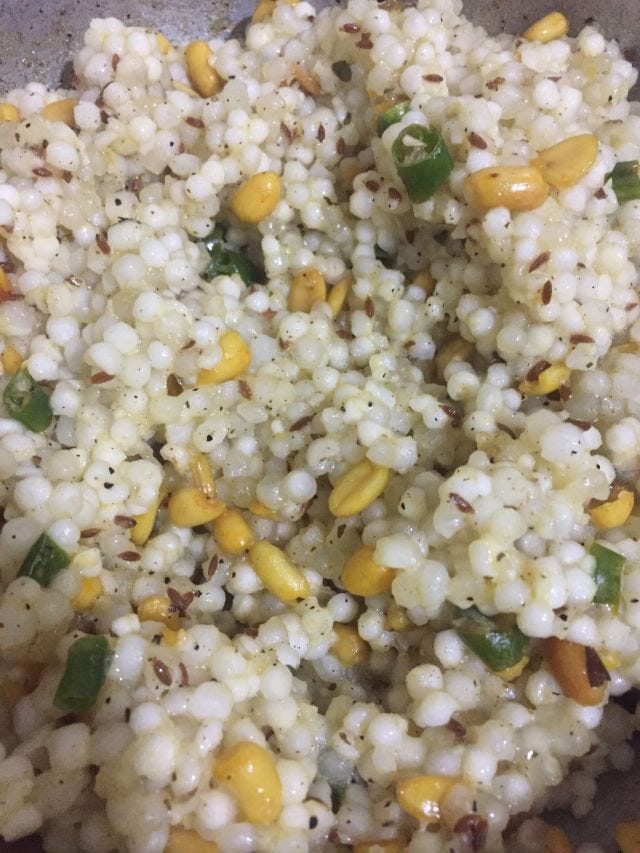 Closeup of sabudana khichdi with peanuts and green chillies.