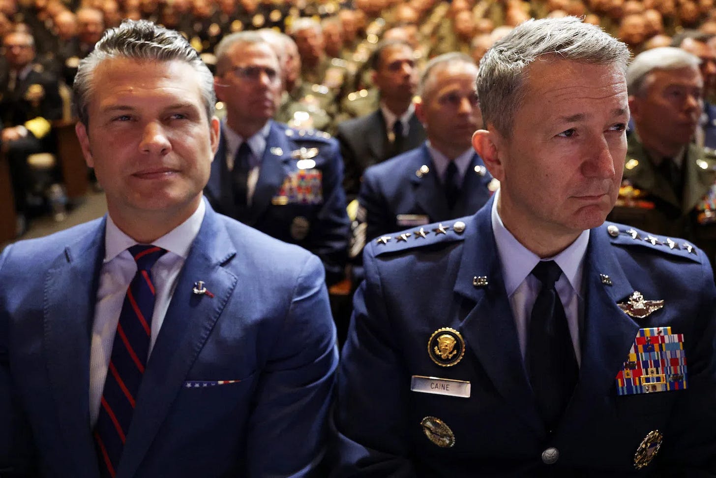 U.S. Defense Secretary Pete Hegseth and Chairman of the Joint Chiefs of Staff Gen. Dan Caine attend a meeting of senior U.S. military members.