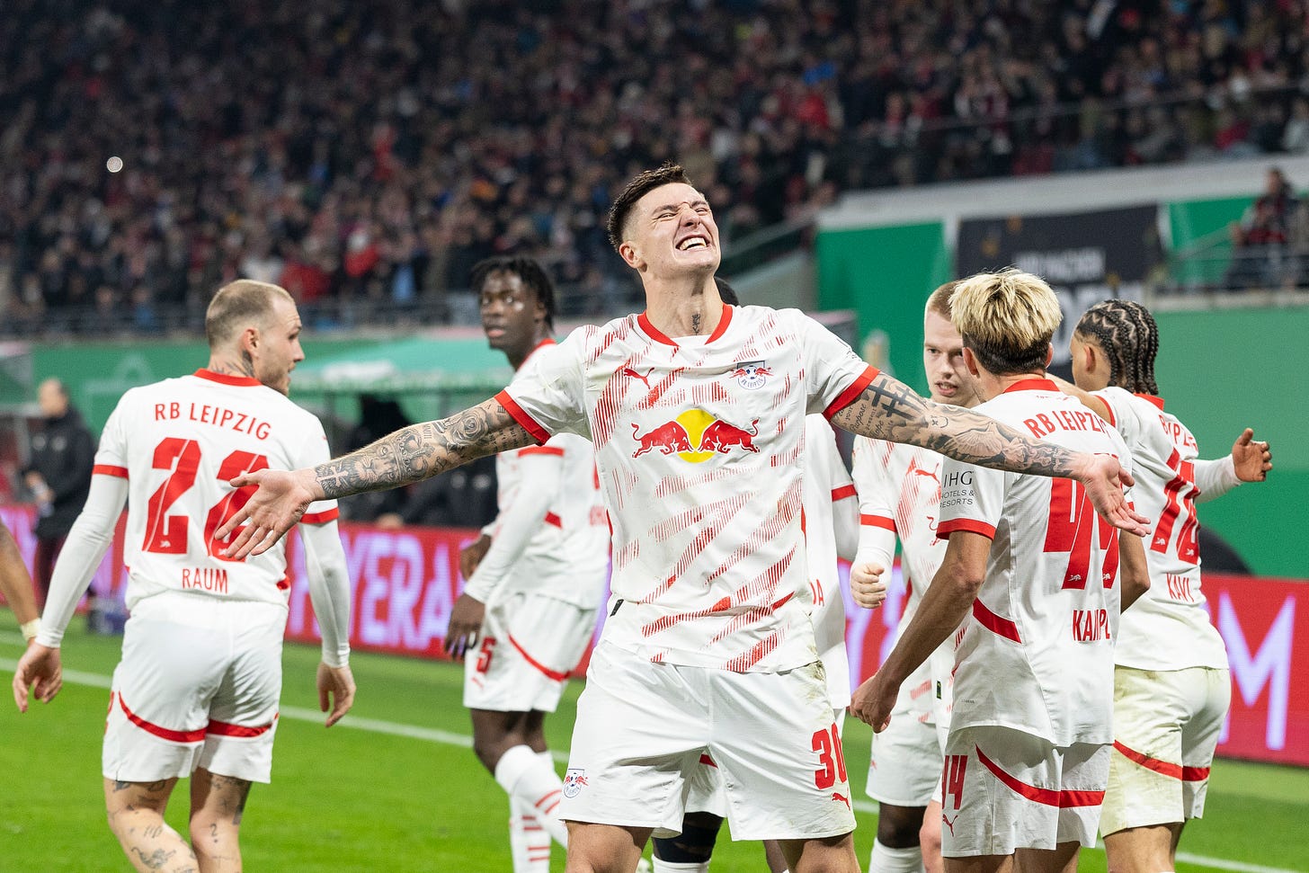 RB Leipzig striker Benjamin Sesko holds out his arms in celebration. RB Leipzig striker Benjamin Sesko holds out his arms in celebration.