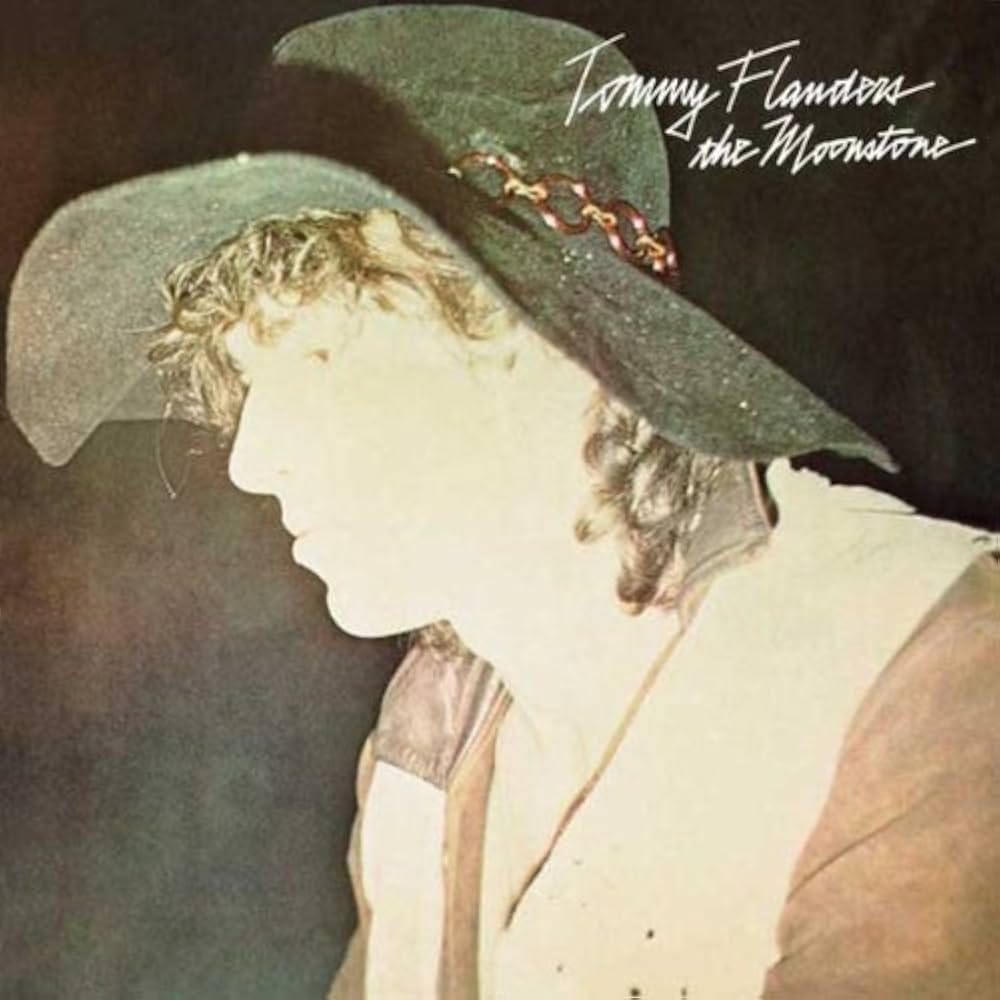 Moonstone album cover; head and shoulders washed out image of Flanders against a neutral background; blonde hair and floppy hat