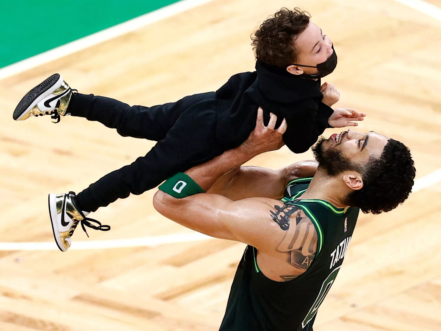 Jayson Tatum lifts his son Deuce in the air on the Boston Celtics' court Jayson Tatum lifts his son Deuce in the air on the Boston Celtics' court