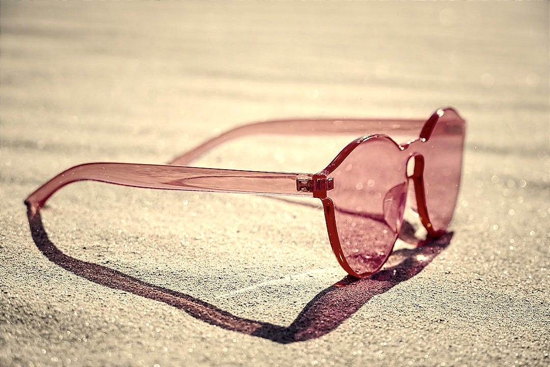 red framed eyeglasses on gray textile red framed eyeglasses on gray textile