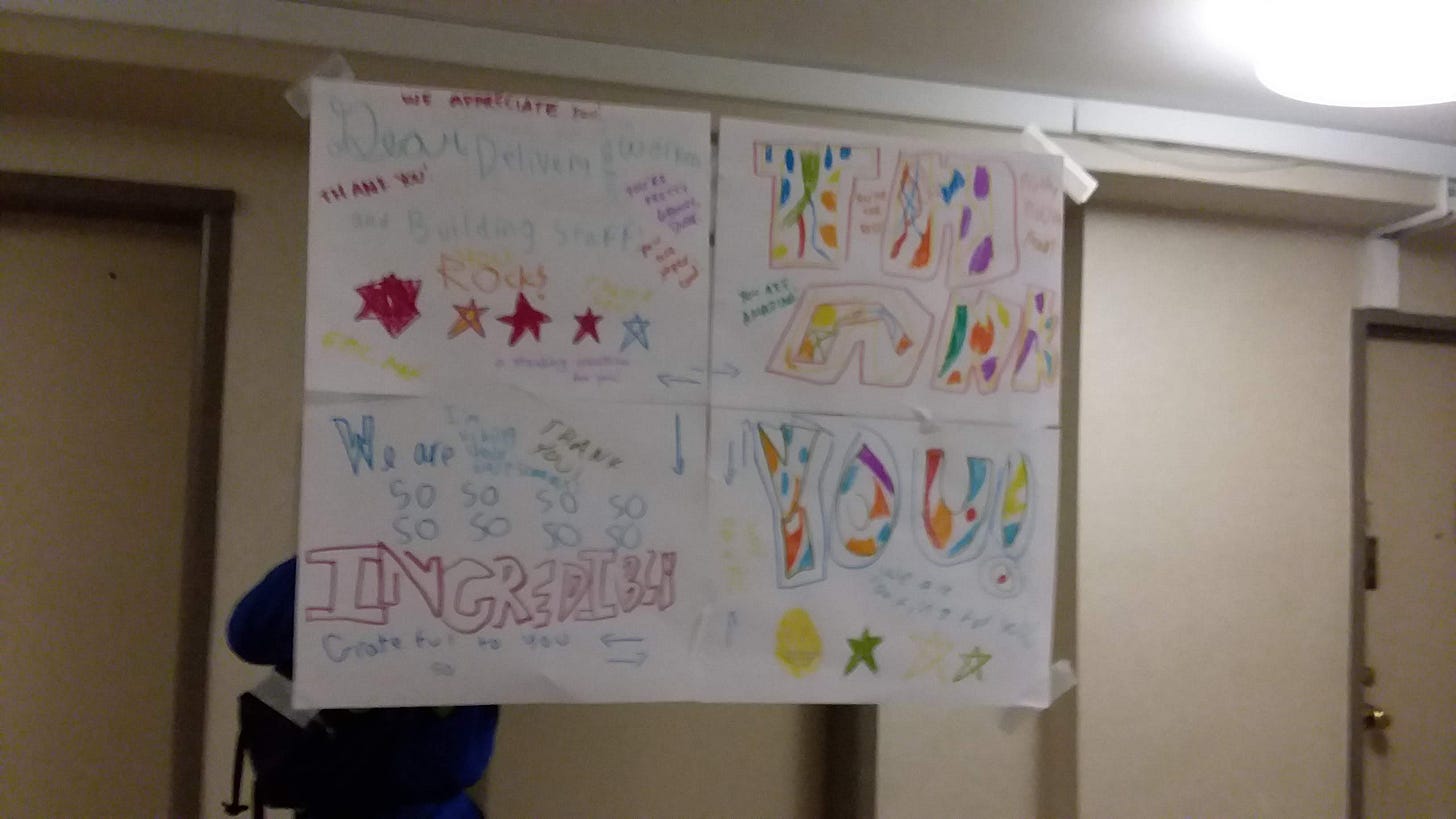 Sign in an NYC hallway, April 2020, with handwritten words of praise, stars, and dots, drawn by the author's kids