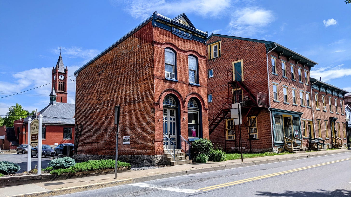 Downtown street in Mifflinburg, Pennsylvania with tower clock in the background.