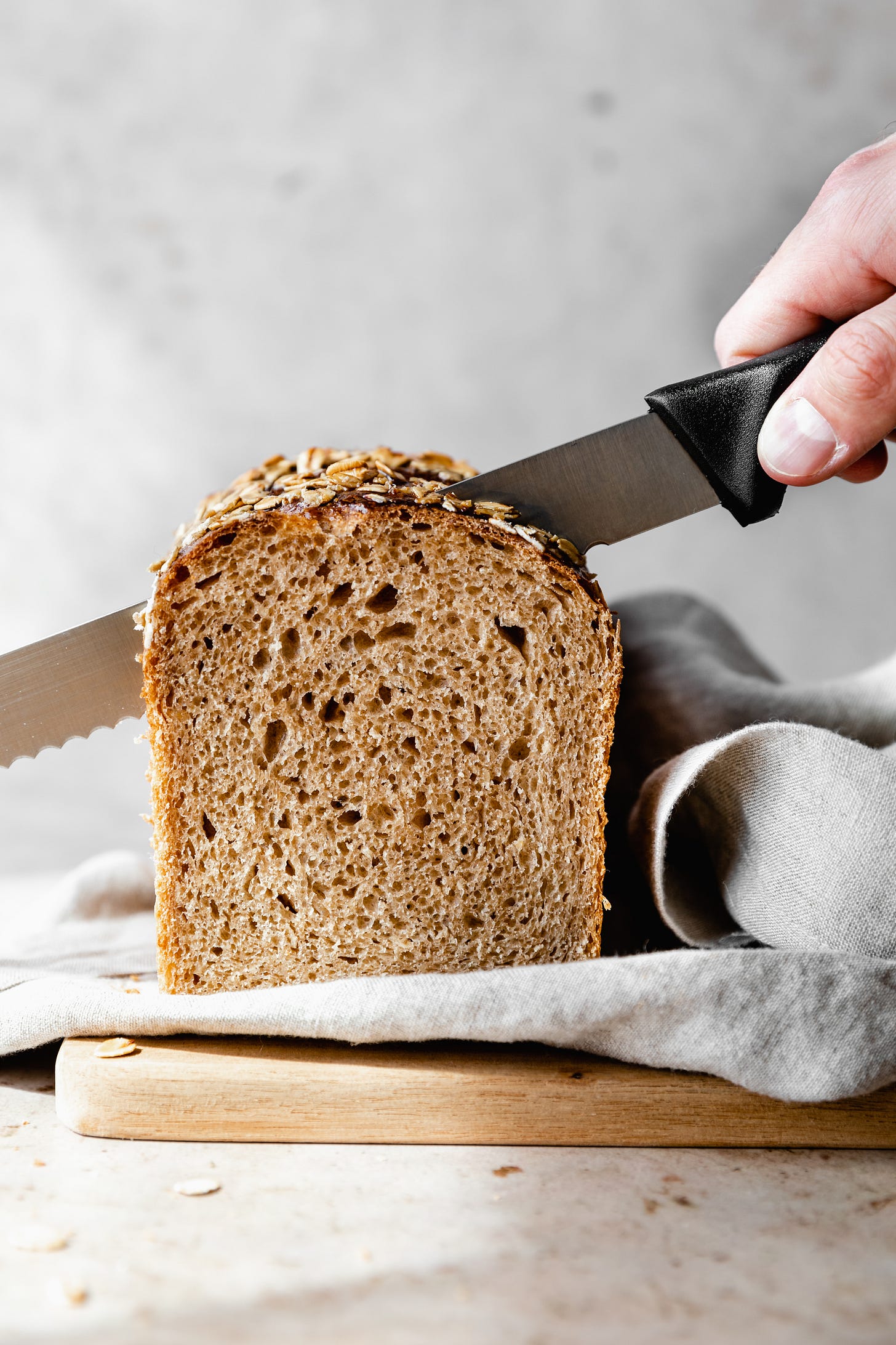 Loaf of plant-based maple oatmeal sandwich bread being sliced