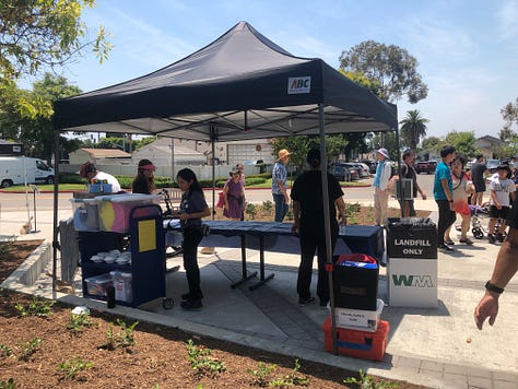 Ribbon Cutting, Chris Slama, and a mom and chld inside the library