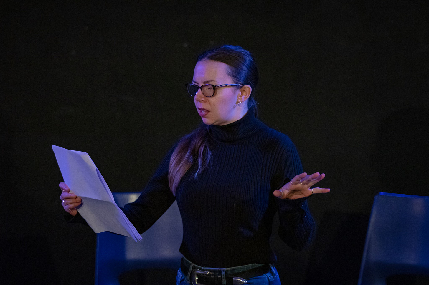 Georgie Wyatt, a white woman with long brown hair, wears glasses and a black jumper, and holds a script. Georgie Wyatt, a white woman with long brown hair, wears glasses and a black jumper, and holds a script.