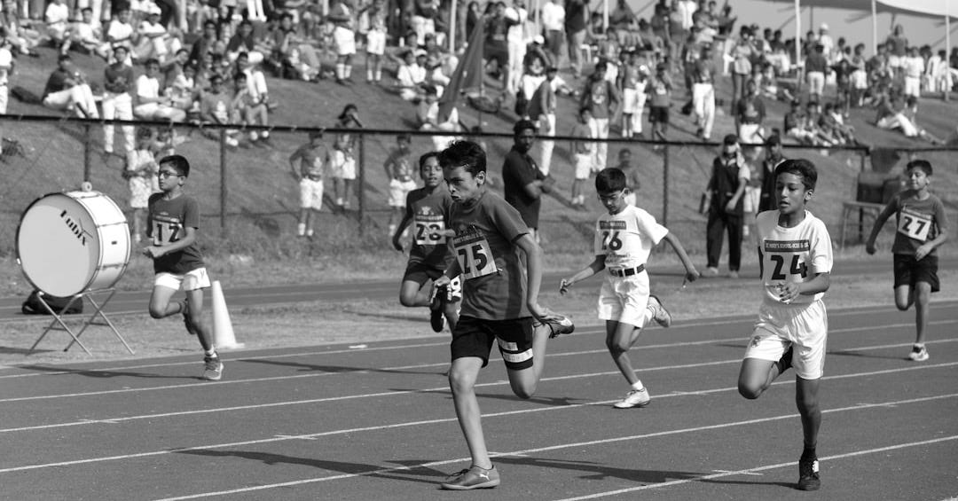 a group of kids running on a track
