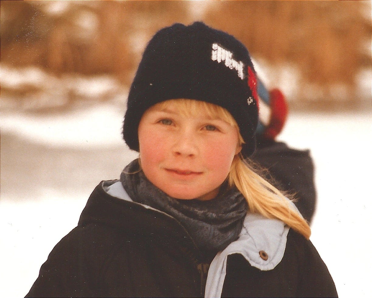 Claudia Kollschen, 8 years old, in winter, dark blue winter jacket, scarf, hat, on a frozen lake