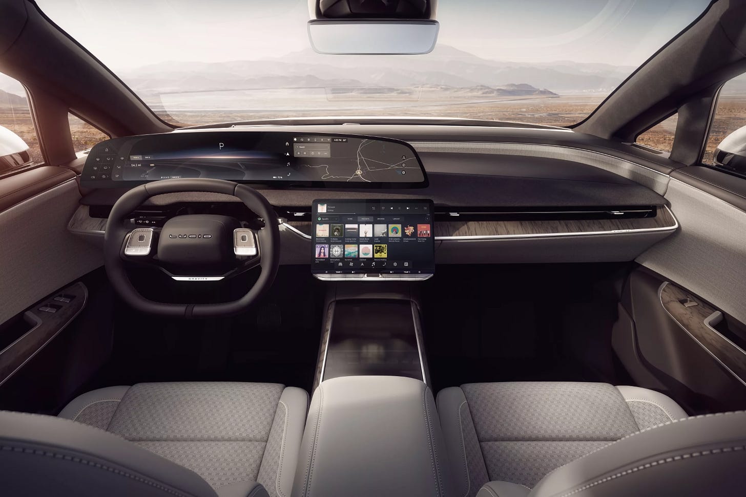 View of the Lucid Gravity electric SUV interior showing the dashboard, taken from the middle of the vehicle's second-row seat.