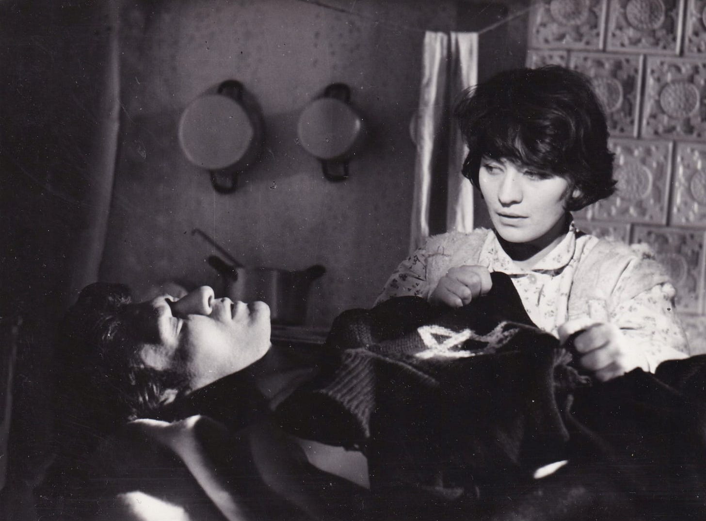 Jakub (Serge Merlin) tries to go to sleep to blot out the horrors of his life as a fugitive Jew, while Kazia (Elżbieta Kępińska) keeps watch over him.